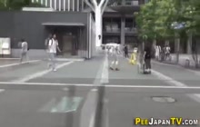 Asian leaves piss puddle in public street